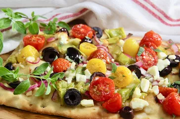 Crispy Chicken Thighs Over Summer Vegetable Medley